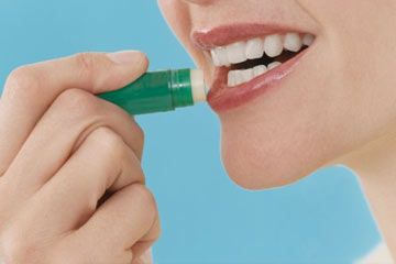 Close-Up of a Woman Applying Lip Balm