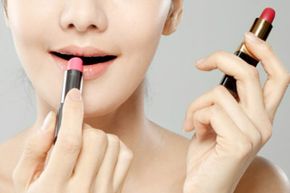 Woman applying two lip products