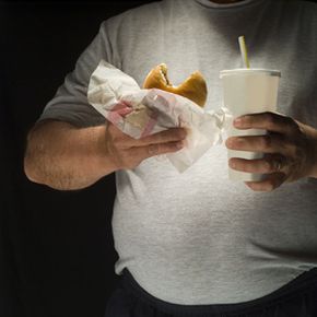 man with hamburger and soda