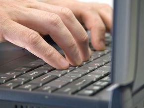 man typing on keyboard