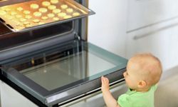 baby in front of oven