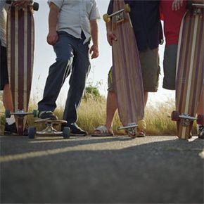 When you're starting out on your brand-new longboard, safety gear is a good idea. Once you're carving like a pro, you can reconsider the knee pads, like these skaters obviously have done.