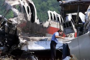A federal investigator examines the remnants of American Airlines flight 1420. You can kind of see how climbing out of that wrecked plane might mess with your mind.