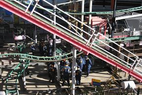 Police officers inspect a roller coaster at the Tokyo Dome City amusement park in Tokyo in 2011 one day after a man died after falling off a ride 8 meters (26 feet) above the ground.
