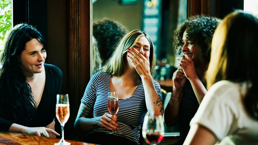 Group of women laughing in bar