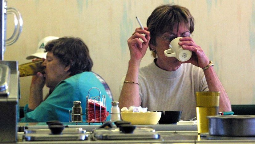 A diner smokes a cigarette with a cup of coffee at the counter of a Duluth, Minnesota, restaurant, before a total indoor smoking went into effect.&nbsp;&nbsp; MARLIN LEVISON/Star Tribune via Getty Images