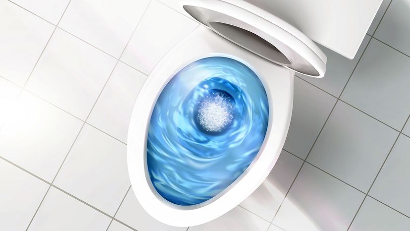 Water swirls around as a low-flow toilet flushes.