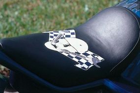 Skull logo of The Wrench CustomCycles appears on the seat.