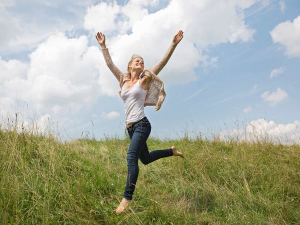 Women smiling in nature's outdoors, radiating happiness.