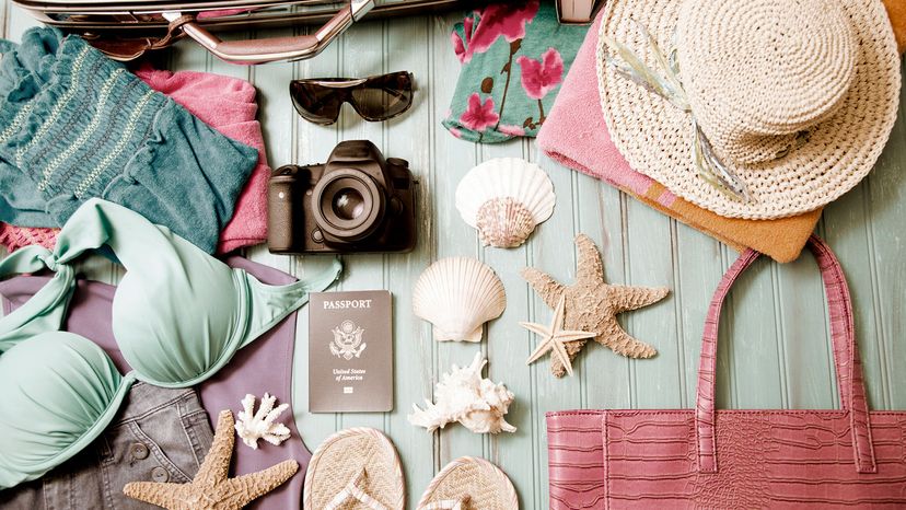 Items to put in a suitcase: straw hat, binoculars, camera, flip flops, shoes, sea shells, book,