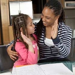 Mom and daughter high-five over homework