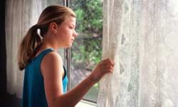 Preteen girl looking out window