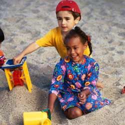 Two kids playing in sand