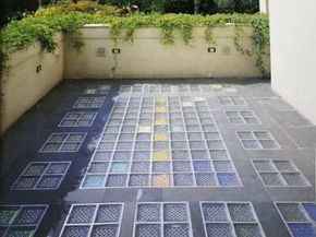 This enclosed patio pairs flagstone with contrasting colored glass, specially coated to reflect light.