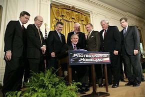 President George W. Bush signs the Patriot Act into law.