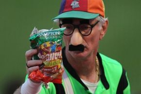 A vendor sells peanuts at a baseball game.