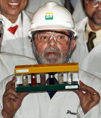 Brazil's president, Luiz Inacio Lula da Silva, holds up a sample of ethanol made from sugar cane, a biofuel -- one of the runners in our allegorical marathon.