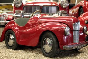 A pedal car at the Haynes Motor Museum is displayed in the Red Room, a collection of over 50 red cars, in Yeovil, England.