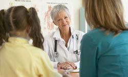 Mother and daughter talk to doctor