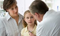 Mother watches doctor use stethescope on daughter