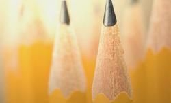 A close-up of two sharpened pencils