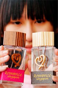 A woman holds &quot;Romance Singapore Eau de Parfum&quot; in 2004. The perfumes, aimed at getting Singaporeans in the mood, were used in a campaign to boost the republic's declining birth rate.