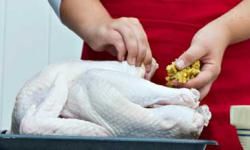 woman stuffing turkey