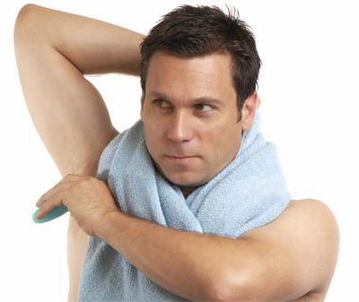 man applying deodorant
