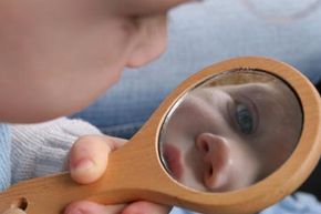 baby looking into a mirror