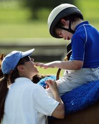 Michael Dedrick-Dwyer, who has autism, takes 30-minute ride on a horse with therapist Rebecca Reubens in Coconut Creek, Fla.