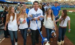 Former Major League Baseball player Steve Garvey (C) and friends at the Bark in the Park at Dodgers' Stadium in Los Angeles.