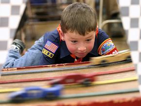 Seven-year-old Carter Pompola watches cars race by him during the annual Cub Scout Pack 136 Pinewood Derby Race at Indian Paintbrush Elementary School in Laramie, Wyo., March 29, 2008.