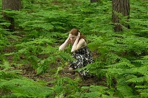 woman in field holding ears