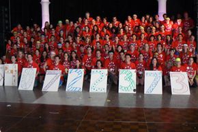 The UCLA Dance Marathon raises money for pediatric AIDS. Here, participants display placards with the grand total of their earnings.