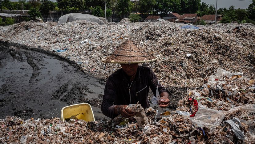 man collects plastic to recylce, Indonesia
