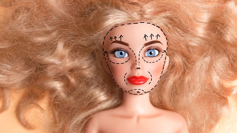 Doll with marker outline on face for plastic surgery