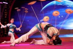 Acrobats performing a plate-spinning routine at Laoshe teahouse in Beijing in 2012