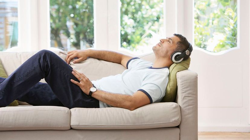 Man at home relaxing and listening to music