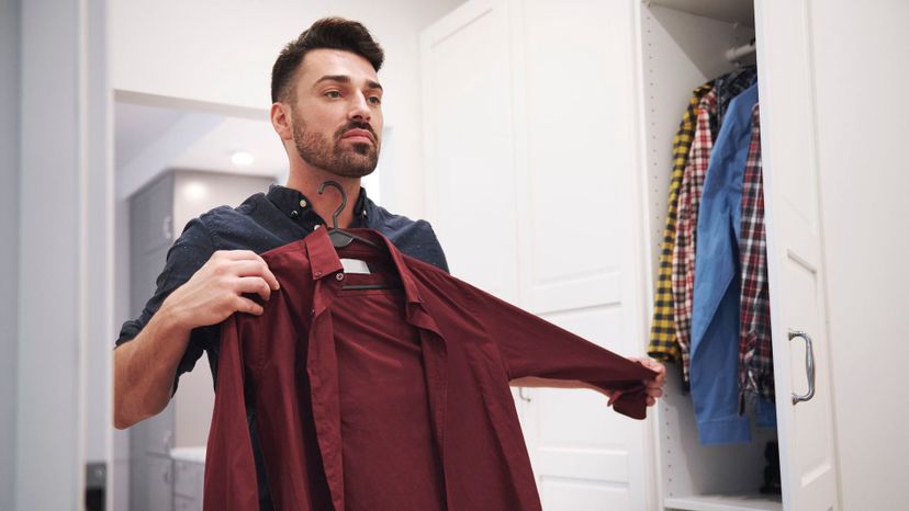 Man choosing shirt from closet