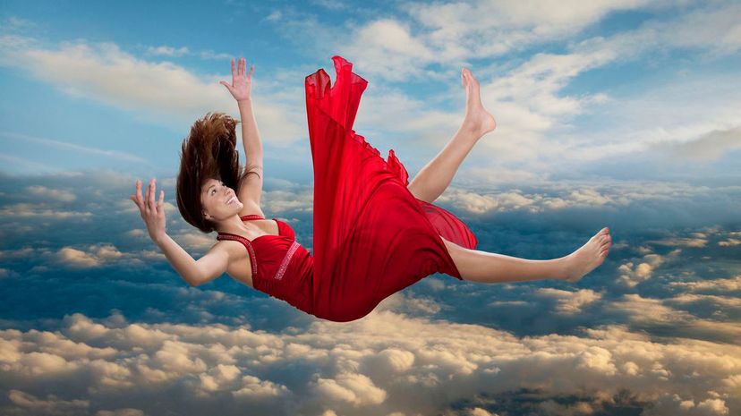 Woman falling through clouds