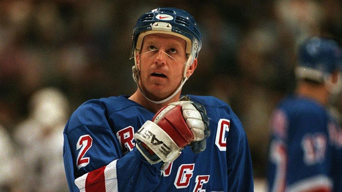 Former Quebec Nordiques players pose after they were introduced