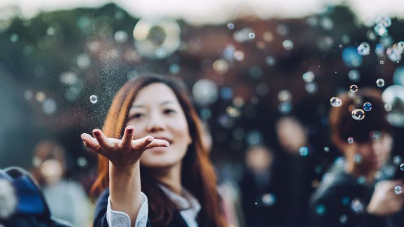 Woman catching bubbles