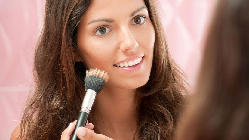 Woman applying makeup