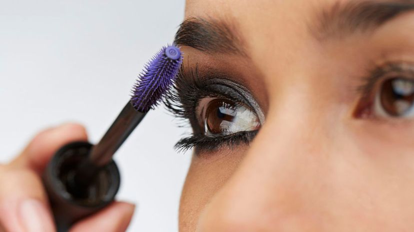 Woman applying mascara