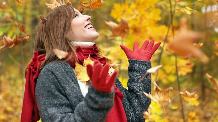 Woman enjoying autumn in maple forest