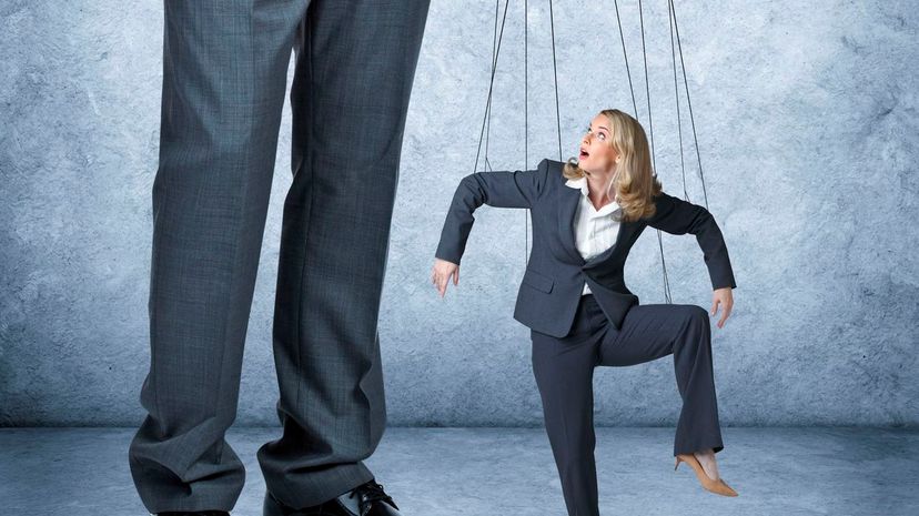 Businesswoman Being Controlled Like A Marionette