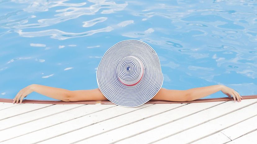 Woman in Pool with Hat