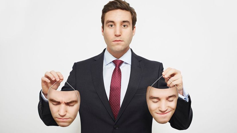 Businessman holding masks