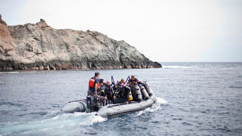 A group of scuba divers in an inflatable boat