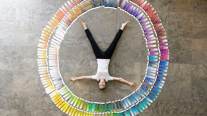 Businessman laying in paint swatches color art